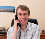 Happy worker speaking to a client on the telephone.