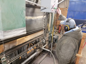 Getting the sandblasting set on a granite headstone on an ABC automatic sandblast curtain